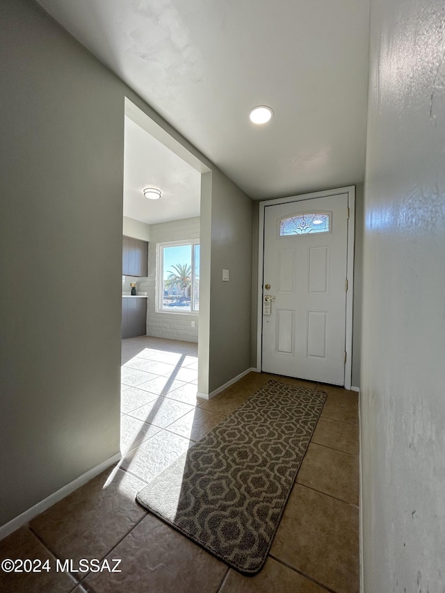 doorway with light tile patterned floors