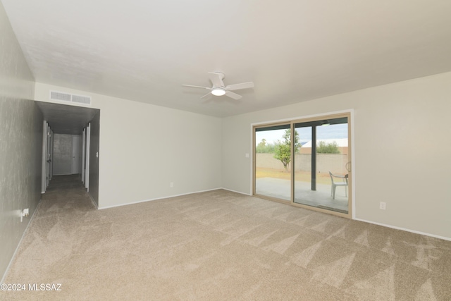 spare room featuring carpet floors and ceiling fan