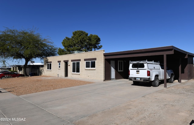 ranch-style house featuring a carport