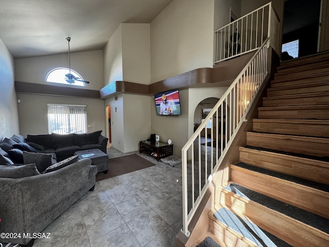 living room featuring tile patterned floors and high vaulted ceiling