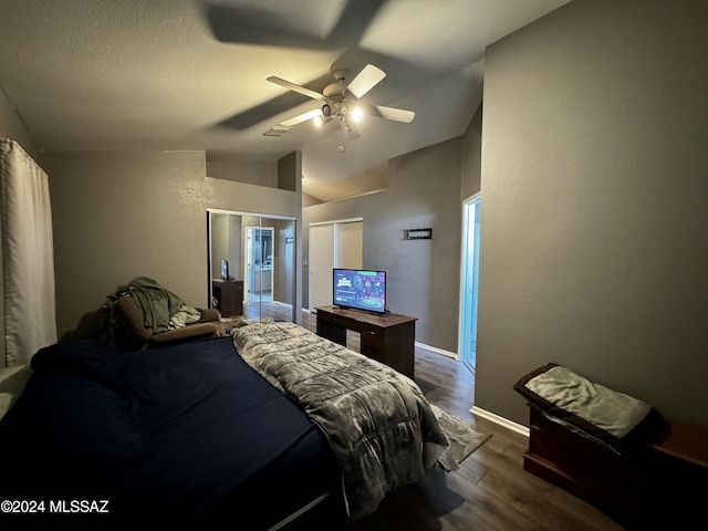 bedroom with lofted ceiling, dark hardwood / wood-style flooring, ceiling fan, a textured ceiling, and a closet