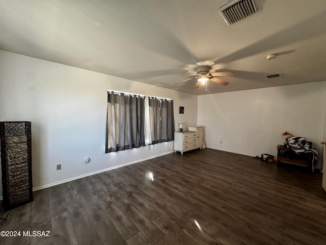 interior space featuring dark wood-type flooring and ceiling fan