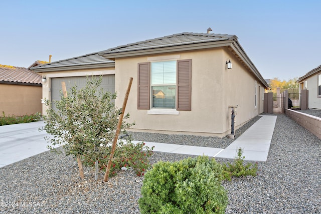 view of side of home featuring a garage