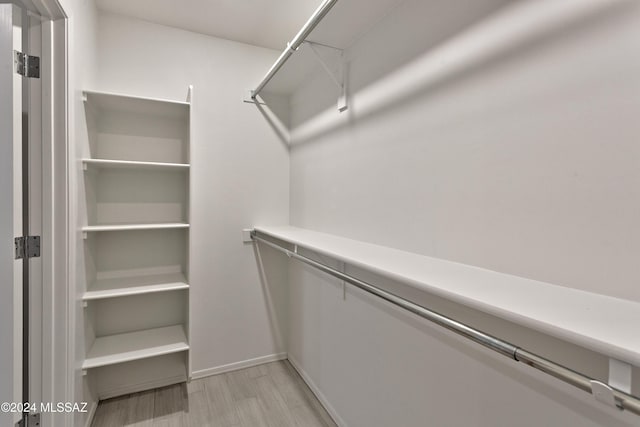 spacious closet featuring light hardwood / wood-style floors