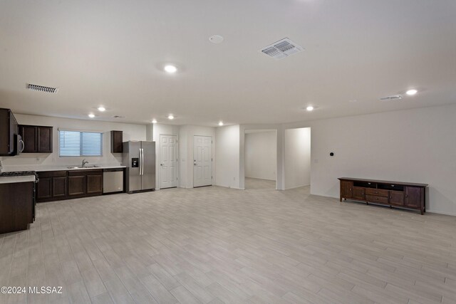 living room with light wood-type flooring and sink