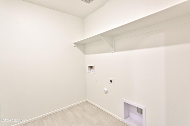 clothes washing area with electric dryer hookup, light hardwood / wood-style floors, gas dryer hookup, and hookup for a washing machine