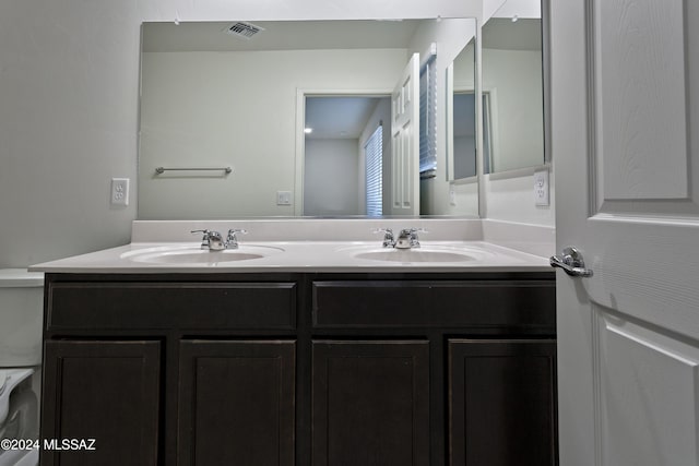 bathroom with vanity and toilet