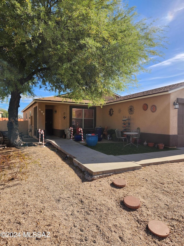 view of front of house featuring a patio area and stucco siding