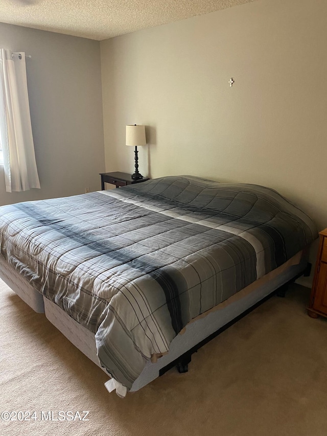 carpeted bedroom with a textured ceiling