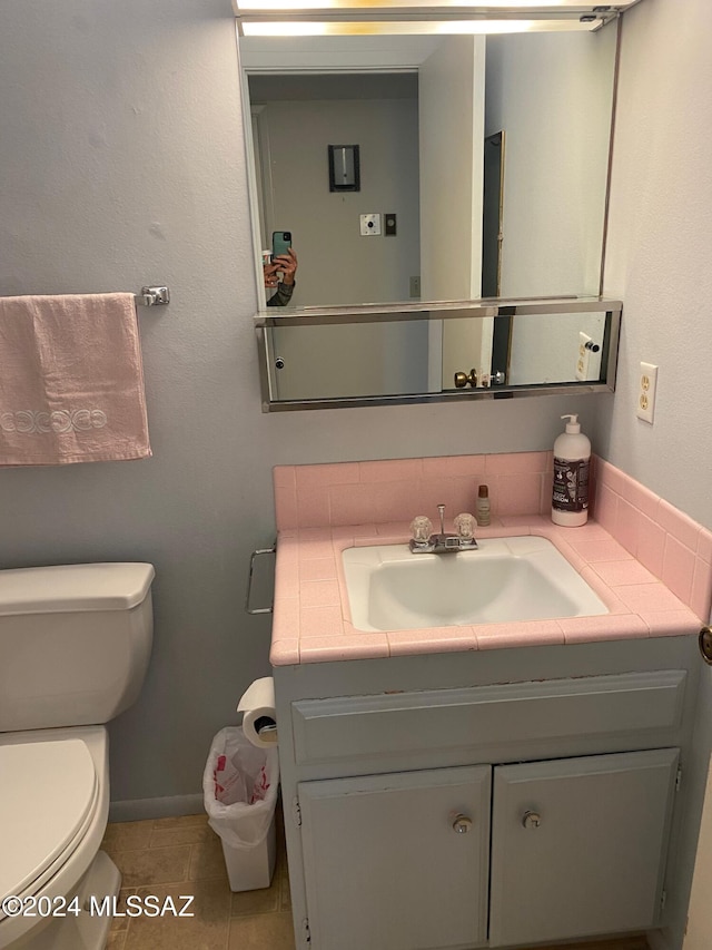 bathroom featuring tile patterned floors, vanity, and toilet