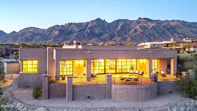 5200 N Camino Antonio, Tucson, AZ 85718 - rear view of house featuring a mountain view, an outdoor fire pit, and a patio area