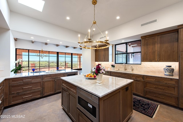 5200 N Camino Antonio, Tucson, AZ 85718 - kitchen with a sink, visible vents, a notable chandelier, and stainless steel microwave