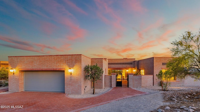 5200 N Camino Antonio, Tucson, AZ 85718 - view of front of property with brick siding, decorative driveway, an attached garage, and a gate