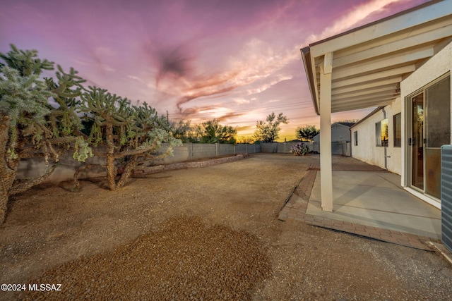 yard at dusk with a patio