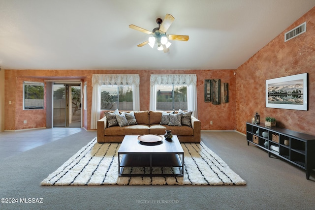 carpeted living room with vaulted ceiling, ceiling fan, and a healthy amount of sunlight