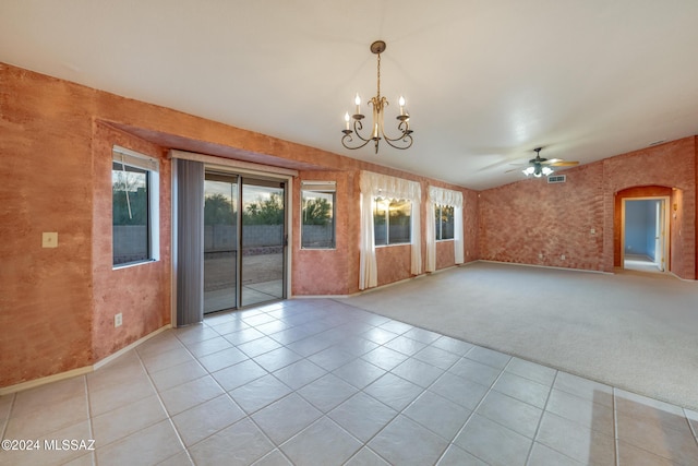 tiled empty room featuring ceiling fan with notable chandelier