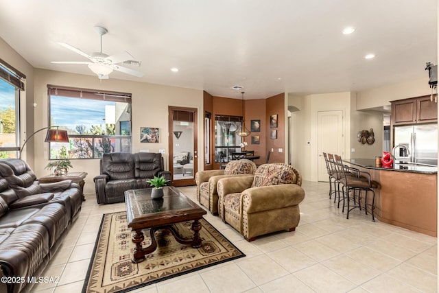 living room featuring ceiling fan and light tile patterned floors