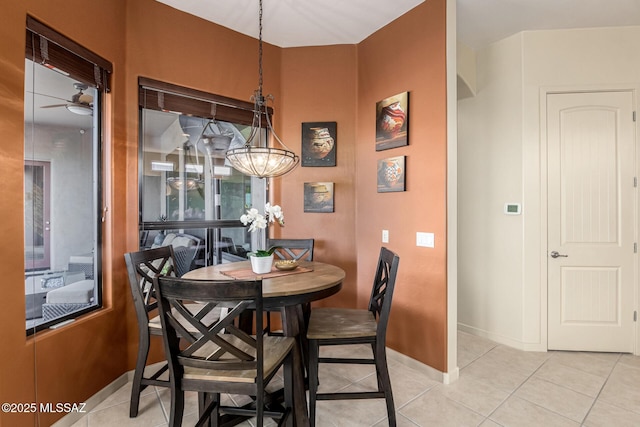 dining area with light tile patterned floors and ceiling fan