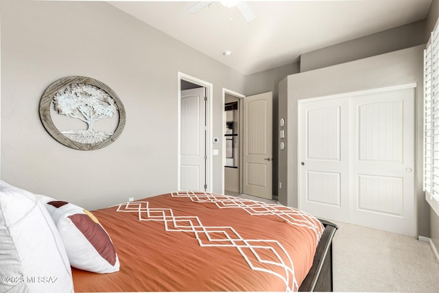 bedroom with a closet, ceiling fan, and carpet flooring