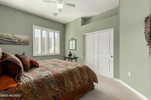 carpeted bedroom featuring ceiling fan and a closet