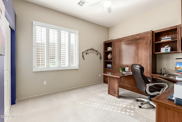 carpeted home office featuring ceiling fan