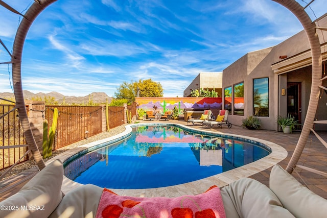 view of swimming pool featuring a mountain view and a patio area