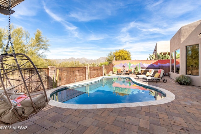 view of pool with a mountain view and a patio