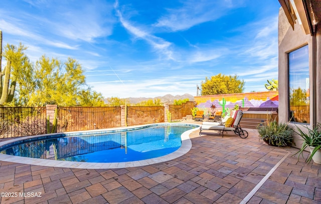 view of pool with a mountain view, a hot tub, and a patio