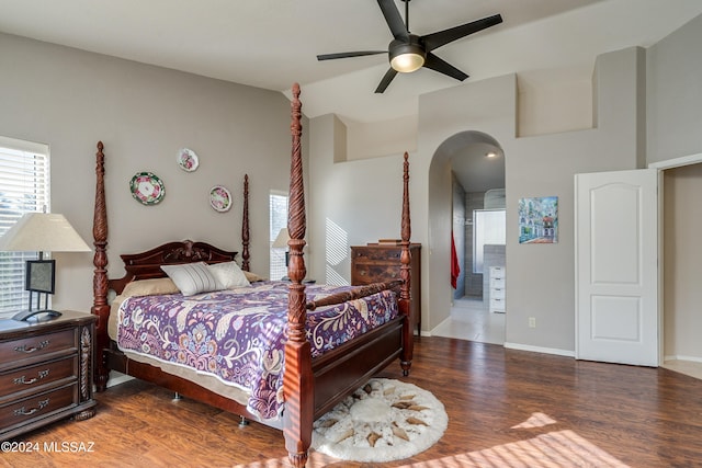 bedroom featuring connected bathroom, ceiling fan, and dark hardwood / wood-style flooring