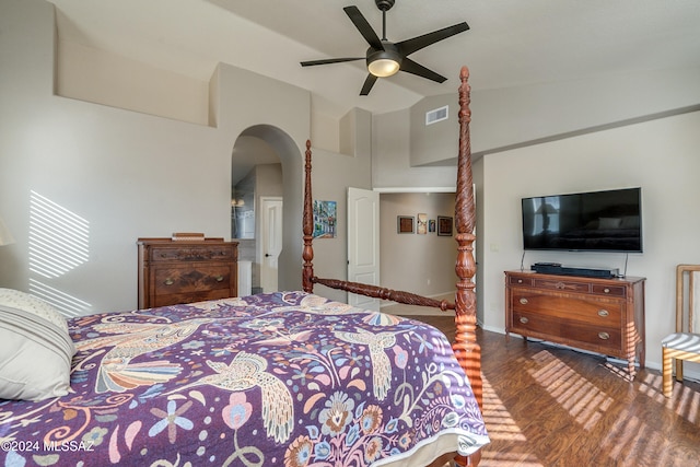 bedroom featuring dark hardwood / wood-style floors, vaulted ceiling, and ceiling fan