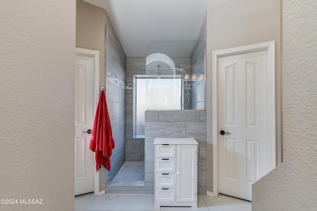 bathroom featuring tile patterned floors and tiled shower