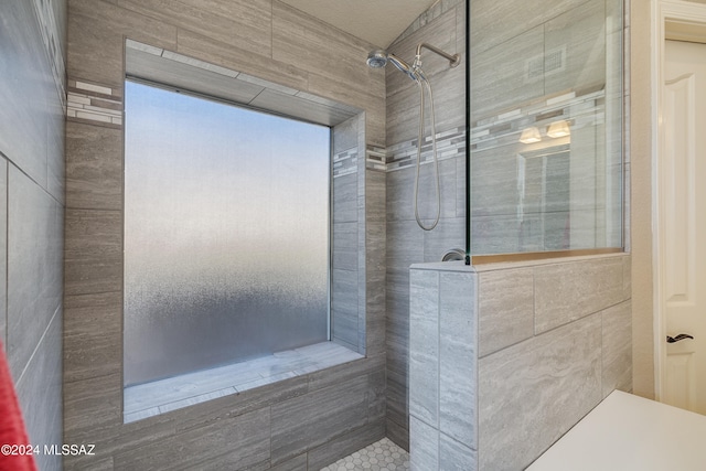 bathroom with tiled shower