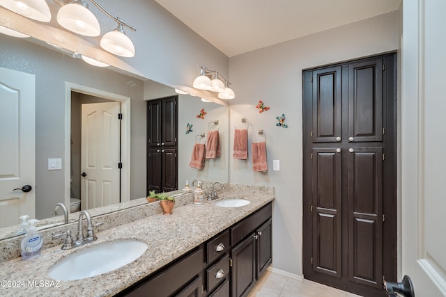 bathroom featuring tile patterned floors, vanity, and toilet