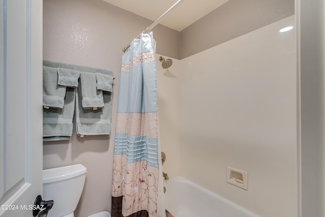 bathroom featuring toilet and shower / bathtub combination with curtain