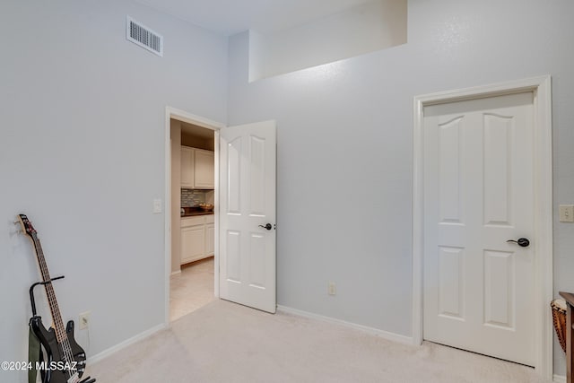 unfurnished bedroom featuring light colored carpet