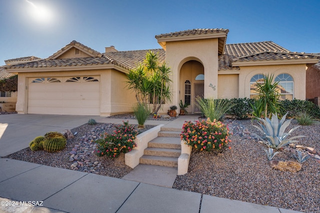 mediterranean / spanish-style house featuring a garage