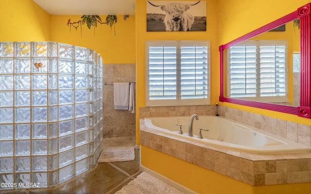 bathroom with a garden tub, tile patterned flooring, and walk in shower