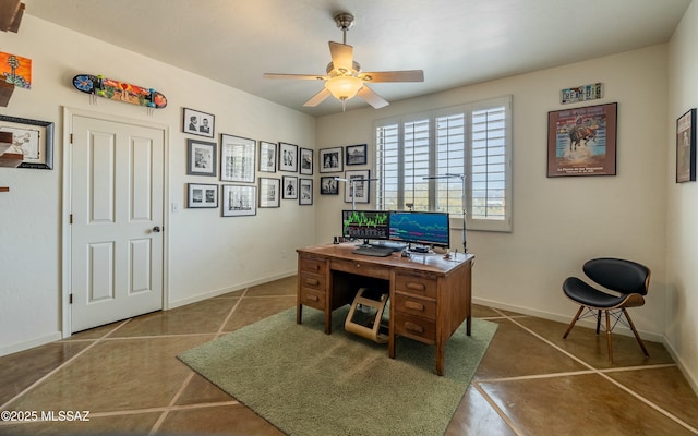 office area with a ceiling fan, baseboards, and tile patterned floors