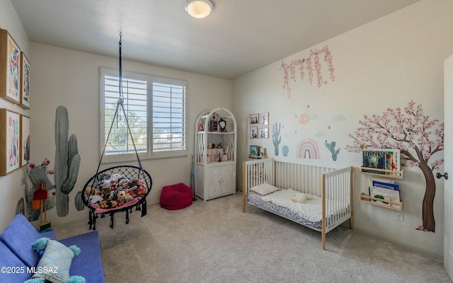 carpeted bedroom featuring a crib