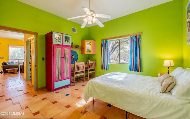 tiled bedroom with ceiling fan and visible vents