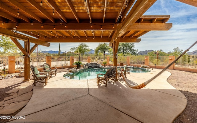 view of swimming pool with a patio area, a fenced backyard, a mountain view, and a fenced in pool