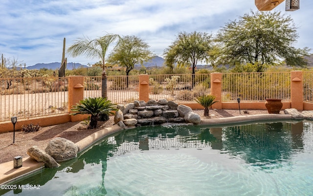 view of pool with fence, a mountain view, and a fenced in pool