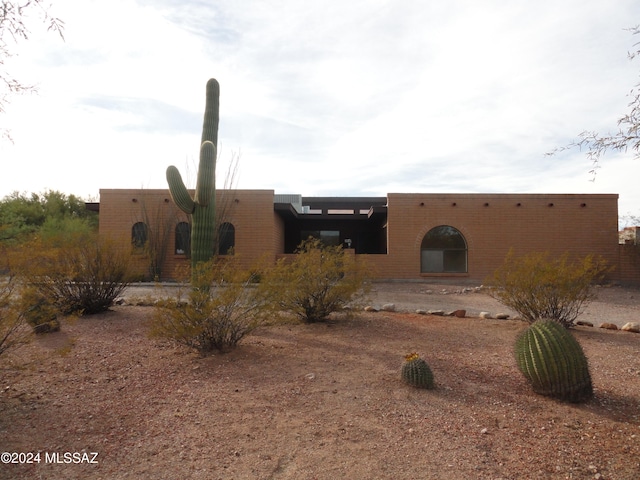 pueblo-style house featuring a patio