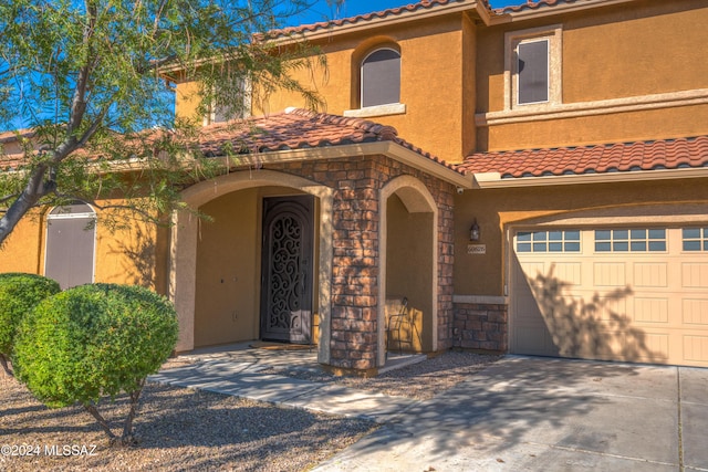 mediterranean / spanish-style home with a garage