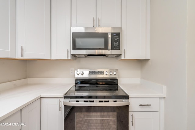 kitchen featuring light stone countertops, white cabinets, and appliances with stainless steel finishes