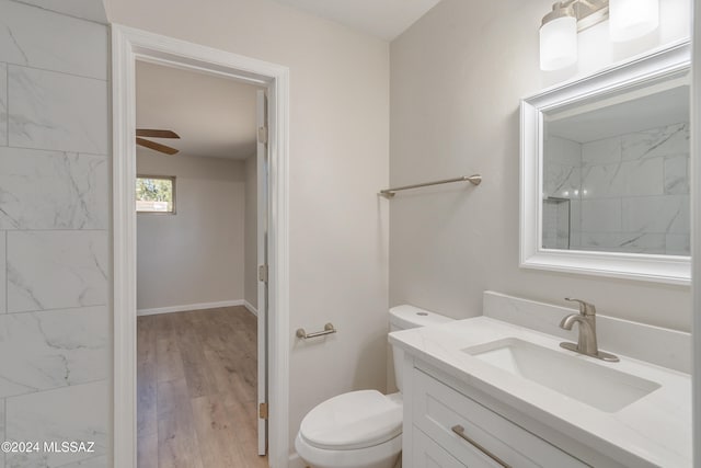 bathroom featuring hardwood / wood-style flooring, vanity, ceiling fan, and toilet