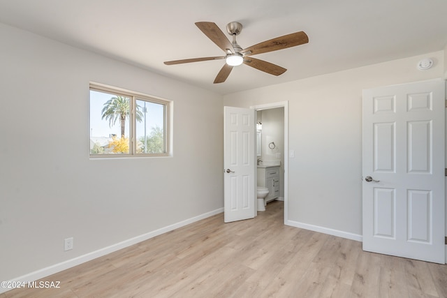 unfurnished bedroom with ceiling fan, ensuite bathroom, sink, and light hardwood / wood-style floors