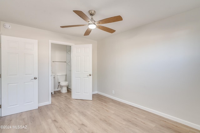 unfurnished bedroom featuring ceiling fan, ensuite bath, and light hardwood / wood-style flooring