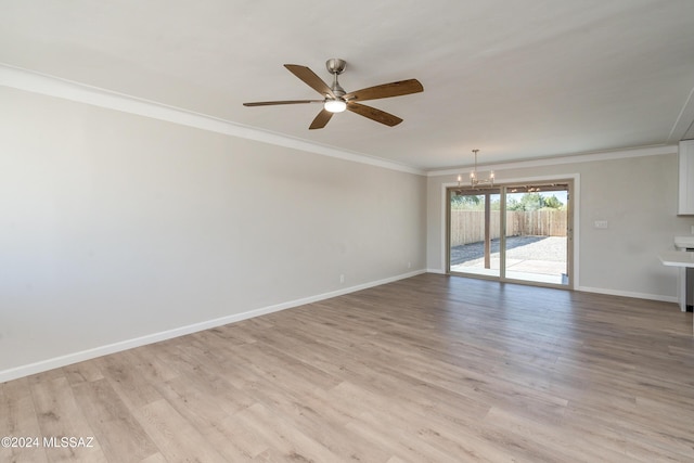 spare room featuring crown molding, ceiling fan with notable chandelier, and light wood-type flooring