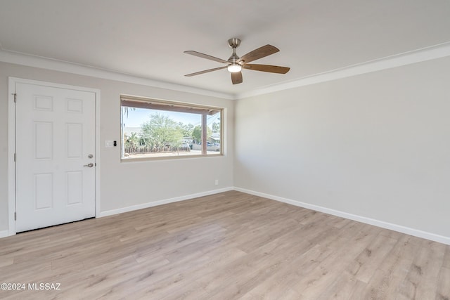 spare room with ornamental molding, ceiling fan, and light wood-type flooring